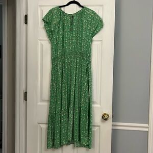 Destination 365 dress. Green print, ruffle bottom, and pockets.